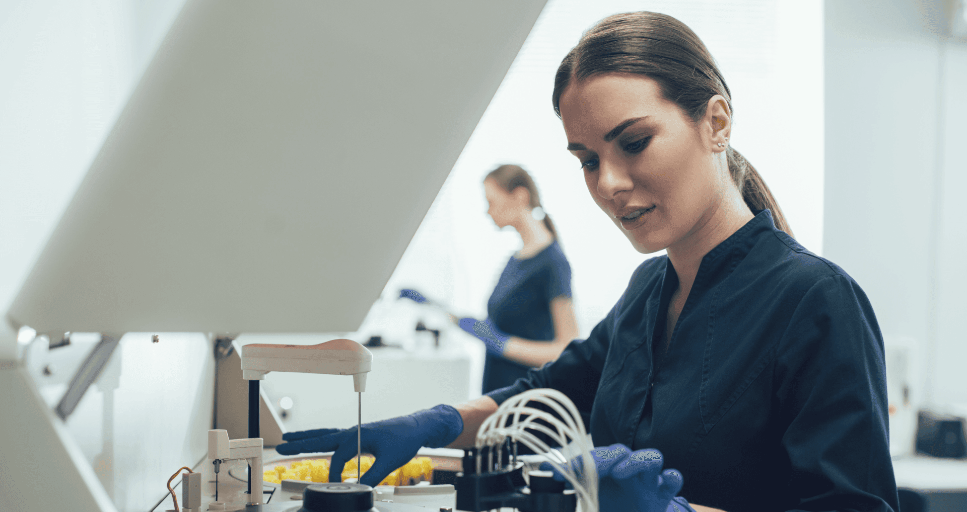 Female medical professional working on medical machinery