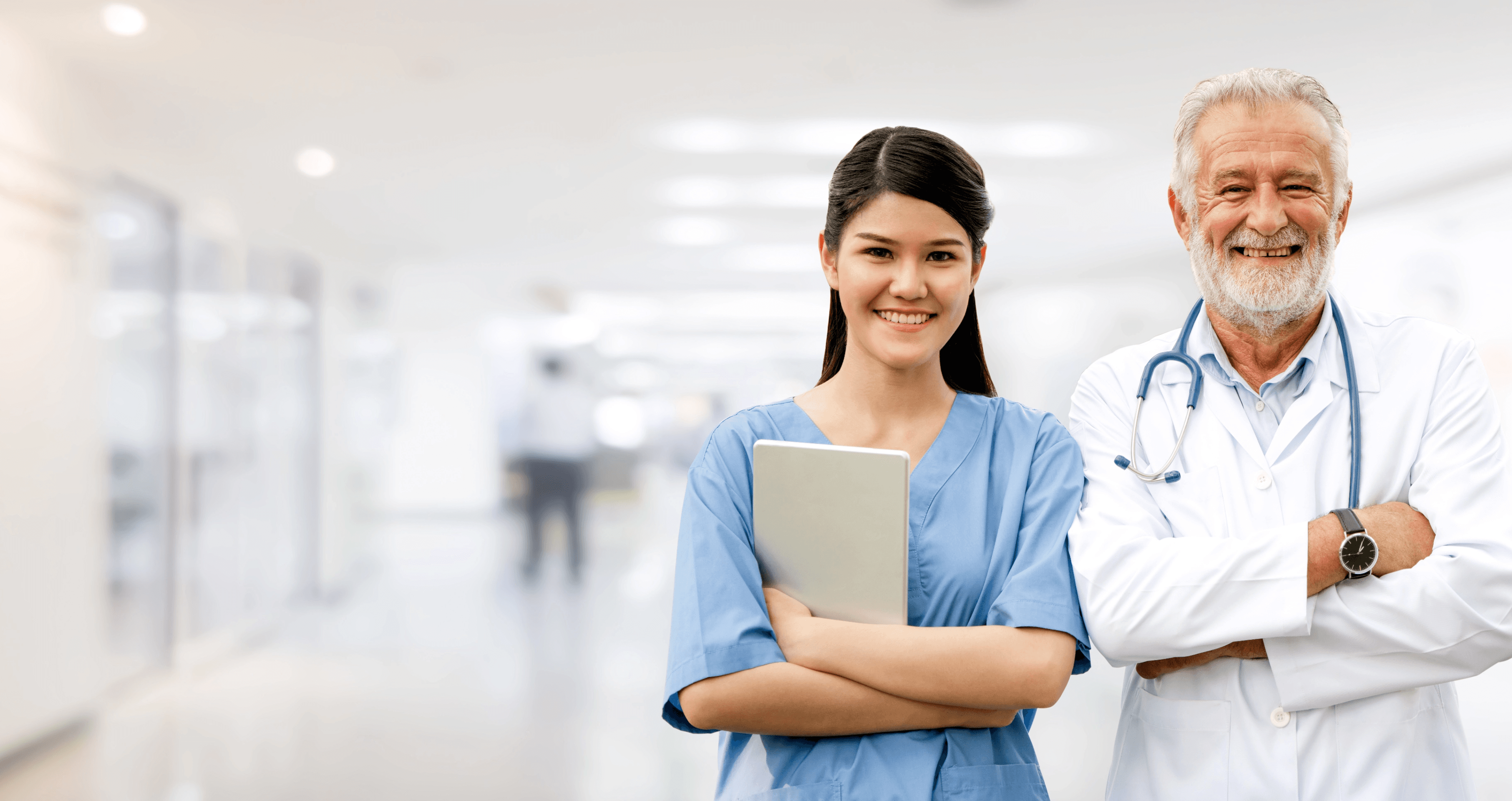 Male and female medical professionals smiling at camera